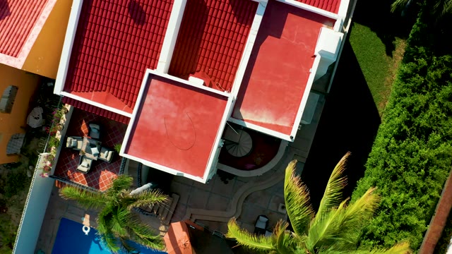 SAN JOSE DEL CABO BCS MEXICO-2021: Red Roofed Building and Pool with Palm Trees