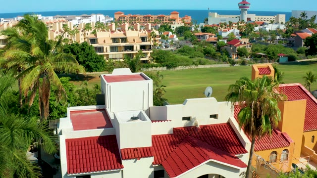 SAN JOSE DEL CABO BCS MEXICO-2021: Red-tiled Roofs and Palm Trees During Aerial Descent