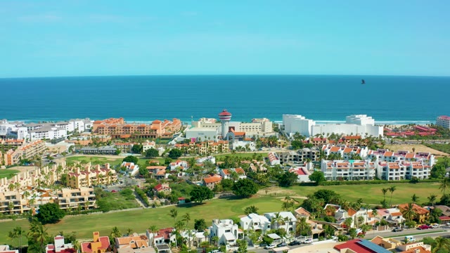 SAN JOSE DEL CABO BCS MEXICO-2021: Coastal Buildings and a Bird Flying Over Ocean