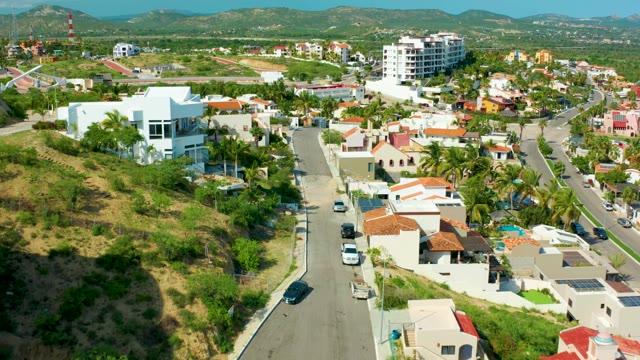 SAN JOSE DEL CABO BCS MEXICO-2021: Hillside Residential Road with Moving Vehicles