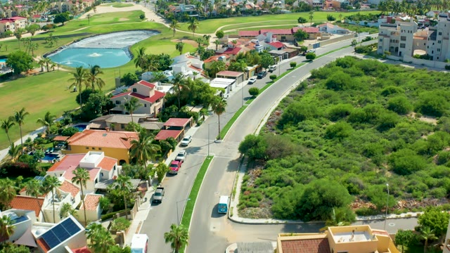 SAN JOSE DEL CABO BCS MEXICO-2021: Vehicles Traveling on Road Adjacent to Golf Course