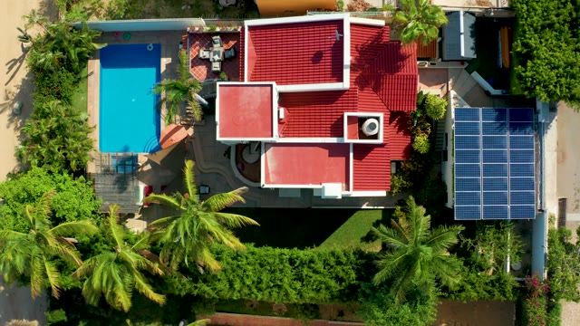 SAN JOSE DEL CABO BCS MEXICO-2021: People Moving Around Pool and House with Solar Panels