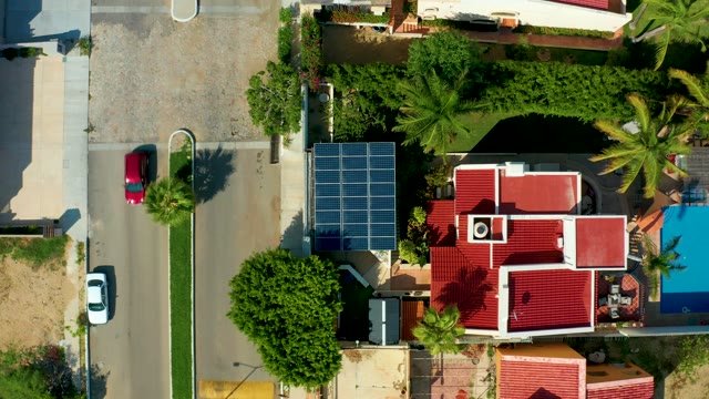 SAN JOSE DEL CABO BCS MEXICO-2021: Red Car Drives Down Residential Street