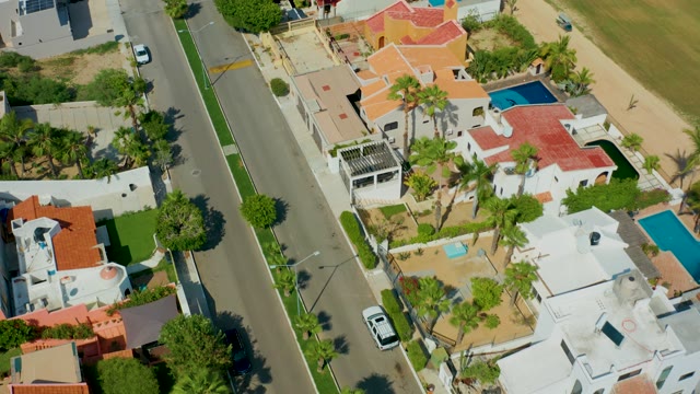 SAN JOSE DEL CABO BCS MEXICO-2021: Residential Street with Houses, Pools, and Palm Trees