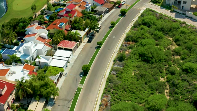 SAN JOSE DEL CABO BCS MEXICO-2021: Residential Road with Red-Tiled Roofs and Lush Greenery