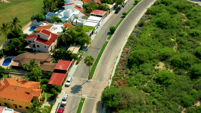 SAN JOSE DEL CABO BCS MEXICO-2021: Residential Street with Cars Driving Past