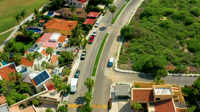 SAN JOSE DEL CABO BCS MEXICO-2021: Suburban Street with Moving Traffic and Houses