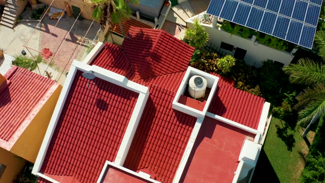 SAN JOSE DEL CABO BCS MEXICO-2021: Red-tiled Roof with Swaying Palm Tree From Above
