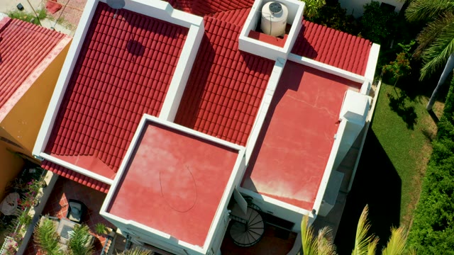SAN JOSE DEL CABO BCS MEXICO-2021: Red-tiled Roof Complex with Moving Vehicle Below