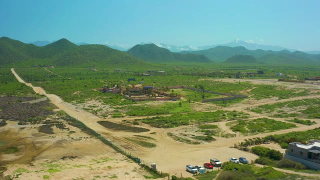 CERRITOS BEACH BCS MEXICO-2021: Vehicles Moving on Rural Dirt Road with Green Hills