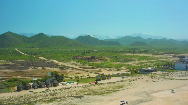 CERRITOS BEACH BCS MEXICO-2021: Vehicles Moving on Rural Dirt Road with Huts and Mountains
