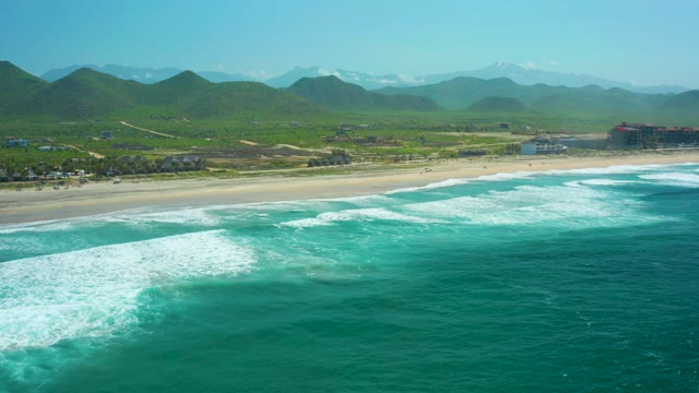CERRITOS BEACH BCS MEXICO-2021: Waves Rolling Toward Sandy Shore with Green Hills