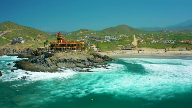 CERRITOS BEACH BCS MEXICO-2021: Coastal Building on Rocky Outcrop with Ocean Waves