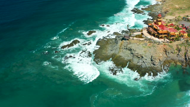 CERRITOS BEACH BCS MEXICO-2021: Coastal Cliff with Red-Roofed Building and Ocean Waves
