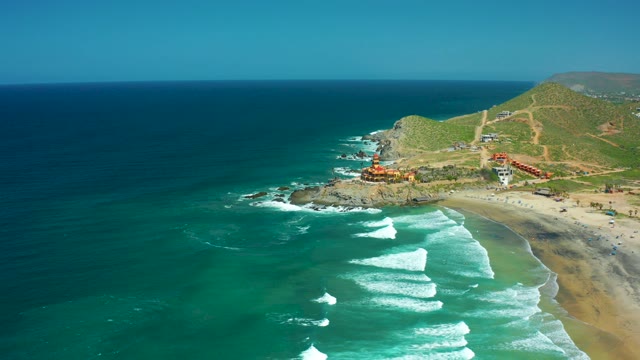 CERRITOS BEACH BCS MEXICO-2021: Waves Rolling Toward Sandy Shore with Coastal Hill