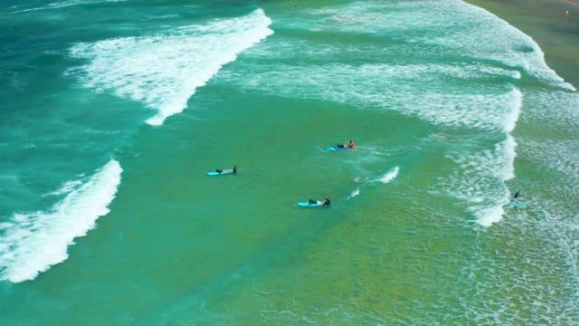 CERRITOS BEACH BCS MEXICO-2021: Surfers Waiting for Waves in Shallow Ocean