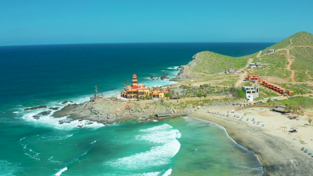 CERRITOS BEACH BCS MEXICO-2021: Coastal Waves Crashing Against Rocky Shore with Lighthouse