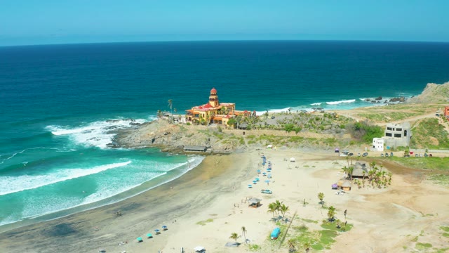 CERRITOS BEACH BCS MEXICO-2021: Waves Crashing on Sandy Beach with Coastal Building