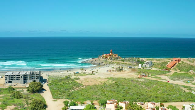 CERRITOS BEACH BCS MEXICO-2021: Ocean Waves Rolling Onto Sandy Shore with Lighthouse