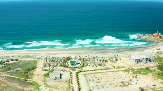 CERRITOS BEACH BCS MEXICO-2021: Waves Rolling Onto Sandy Beach with Coastal Buildings