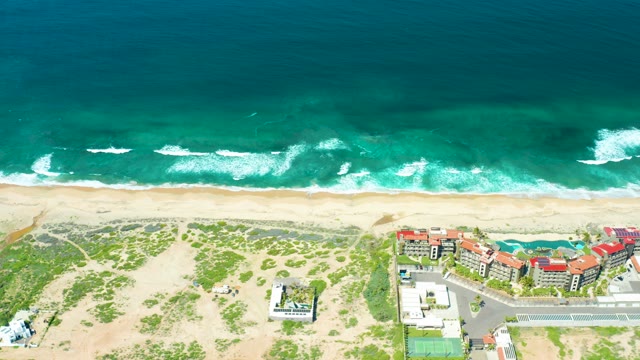 CERRITOS BEACH BCS MEXICO-2021: Waves Rolling Onto Sandy Beach with Dunes and Buildings