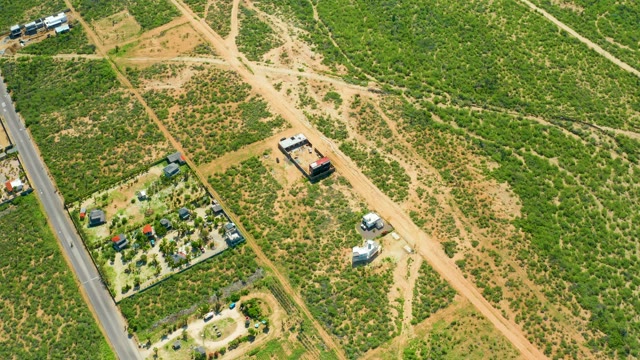 CERRITOS BEACH BCS MEXICO-2021: Vehicles Traveling on a Dirt Road in a Grassy Area