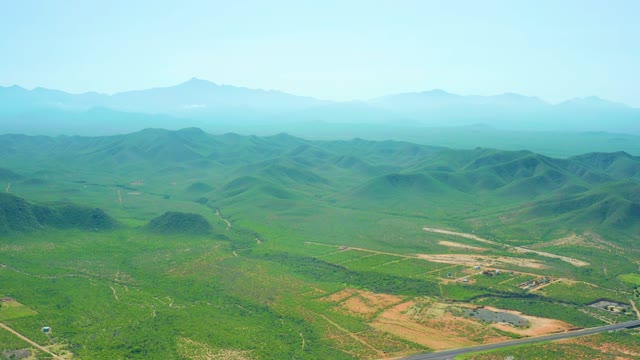 CERRITOS BEACH BCS MEXICO-2021: Green Valley with Rolling Hills and Moving Vehicle