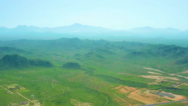 CERRITOS BEACH BCS MEXICO-2021: Hilly Green Landscape with Vehicle Moving on Road