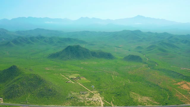 CERRITOS BEACH BCS MEXICO-2021: Vehicle Traveling on Rural Road Through Green Hills