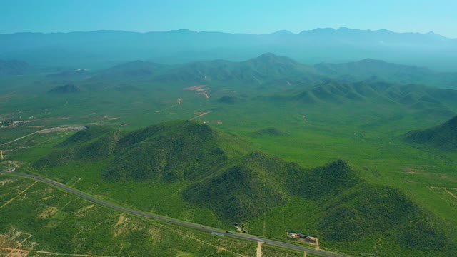 CERRITOS BEACH BCS MEXICO-2021: Vehicles Moving on a Winding Road Through Green Hills