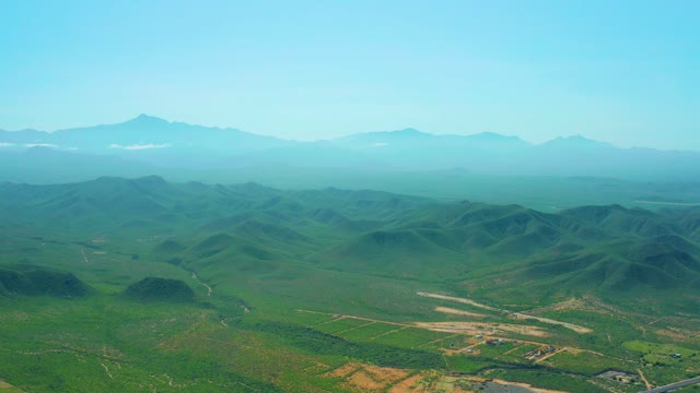 CERRITOS BEACH BCS MEXICO-2021: Slow Pan of Green Valley and Distant Mountains