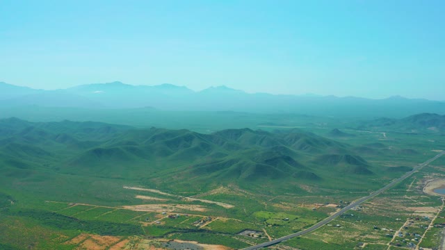 CERRITOS BEACH BCS MEXICO-2021: Rolling Green Hills and Road in Rural Landscape