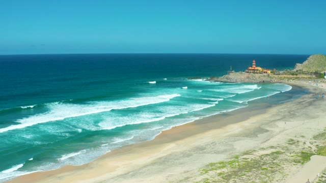 CERRITOS BEACH BCS MEXICO-2021: Waves Crashing on Sandy Shore with Lighthouse
