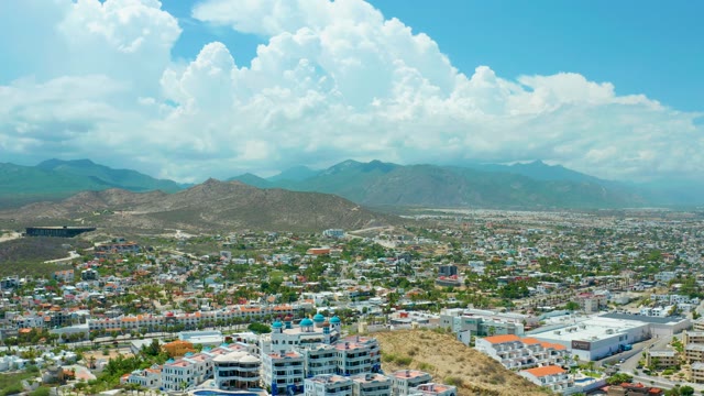 SAN JOSE DEL CABO BCS MEXICO-2021: Cityscape with Distant Mountains and Clouds