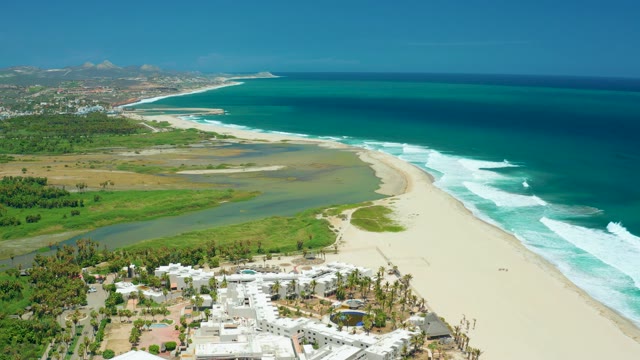 SAN JOSE DEL CABO BCS MEXICO-2021: Coastal River Merging with Ocean at Sandy Shoreline