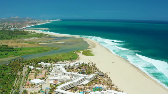 SAN JOSE DEL CABO BCS MEXICO-2021: Beach Shore with Rolling Waves and Coastal Buildings