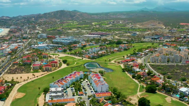 SAN JOSE DEL CABO BCS MEXICO-2021: Golf Course with Residential Buildings and Distant Mountains