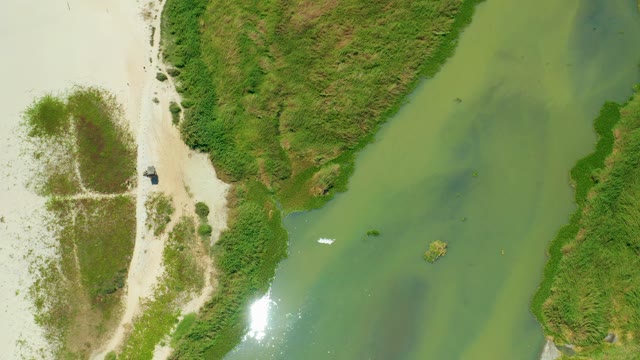 SAN JOSE DEL CABO BCS MEXICO-2021: Small Boat Moving in Shallow Water Near Sandy Shore
