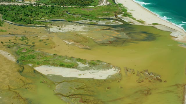 SAN JOSE DEL CABO BCS MEXICO-2021: Muddy Estuary Flowing to Sandy Beach and Ocean