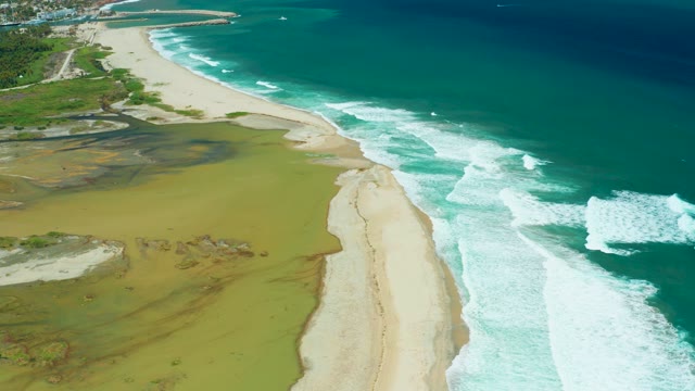 SAN JOSE DEL CABO BCS MEXICO-2021: Waves Rolling Onto Sandy Beach and Muddy Shoreline