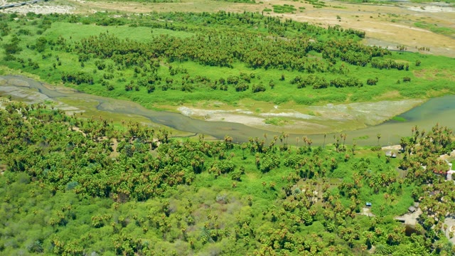SAN JOSE DEL CABO BCS MEXICO-2021: Winding River and Moving Vehicle in Lush Green Landscape