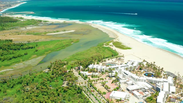 SAN JOSE DEL CABO BCS MEXICO-2021: Lagoon Merging with Ocean Near Sandy Beach and Resorts