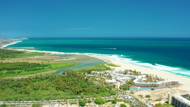 SAN JOSE DEL CABO BCS MEXICO-2021: Coastal Scene with Boat Moving Along Shoreline