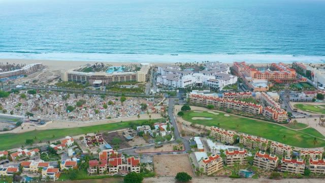 SAN JOSE DEL CABO BCS MEXICO-2021: Beachgoers and Resort Buildings by the Ocean