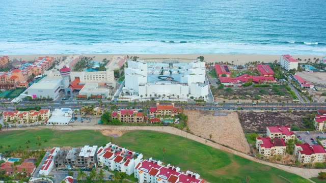 SAN JOSE DEL CABO BCS MEXICO-2021: Coastal Buildings with Shifting Roof Colors and Ocean Waves