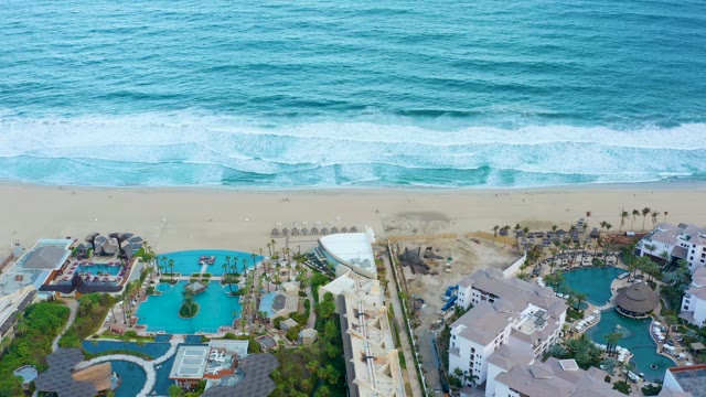 SAN JOSE DEL CABO BCS MEXICO-2021: Waves Rolling Onto Sandy Beach near Resort
