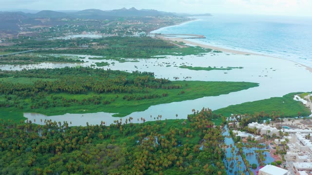 SAN JOSE DEL CABO BCS MEXICO-2021: Wetland River Flowing to Sandy Beach