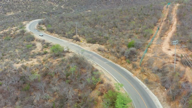 LA PLAYITA LOS CABOS MEXICO-2021: Car Traveling on Winding Mountain Road