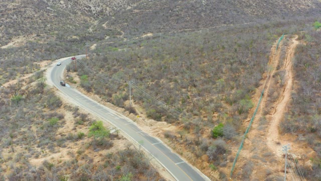LA PLAYITA LOS CABOS MEXICO-2021: Vehicles Moving Along a Winding Hilly Road