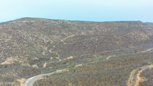 LA PLAYITA LOS CABOS MEXICO-2021: Winding Mountain Road with Passing Car